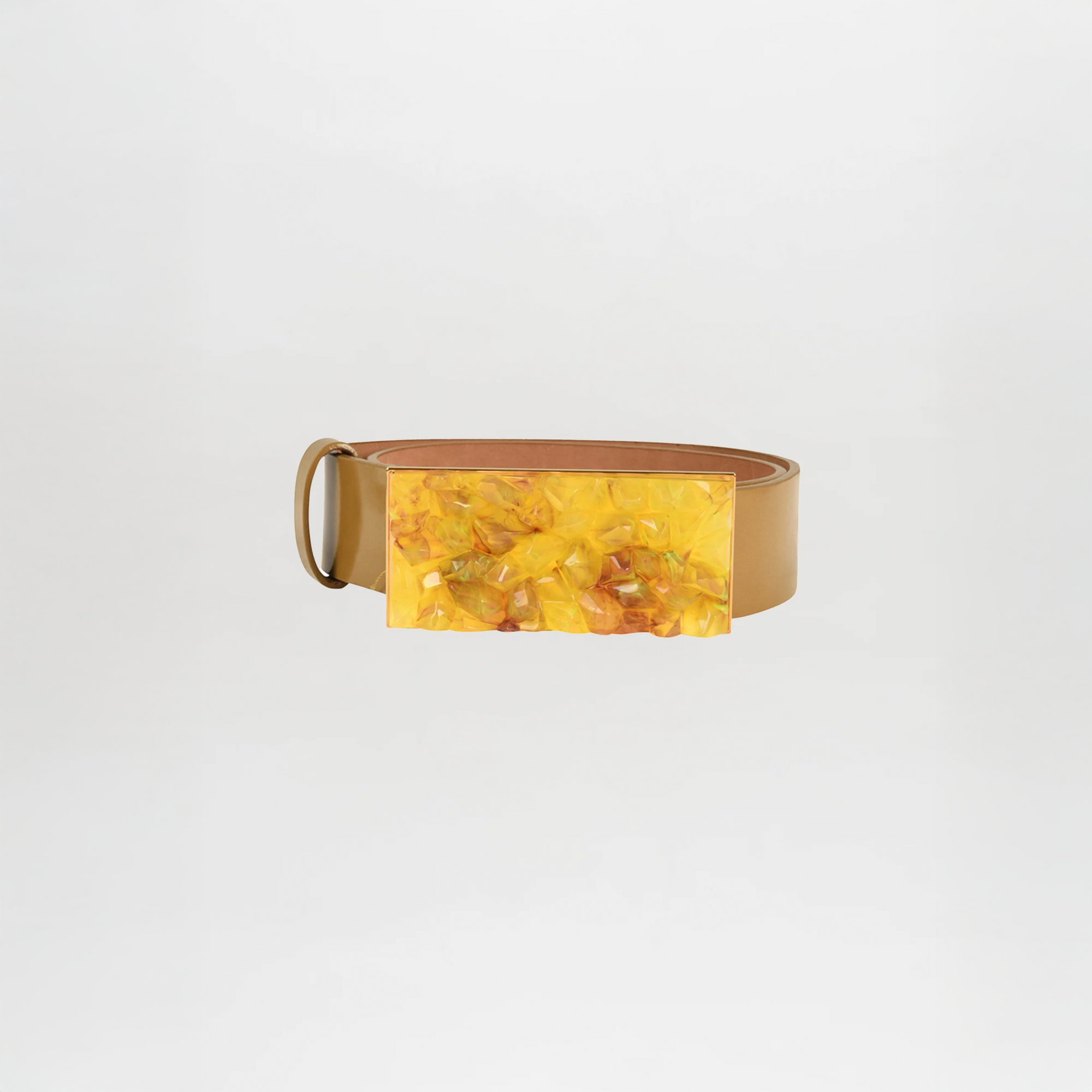 The Dora Belt Mustard by Silvia Tcherassi is crafted from camel leather in tan and features a large rectangular yellow marbled buckle, shown on a plain white background.