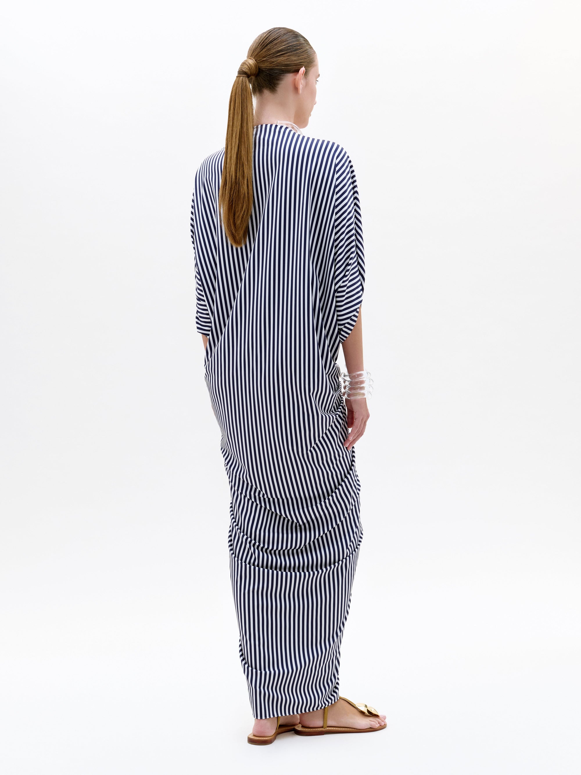 Woman wearing a black and white striped outfit on a white background