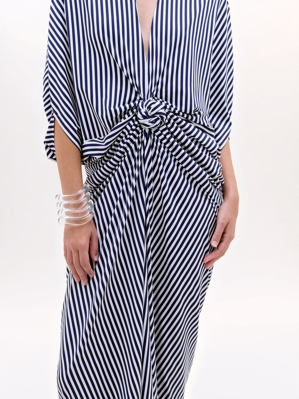 Black and white striped dress with a tie waist on a white background