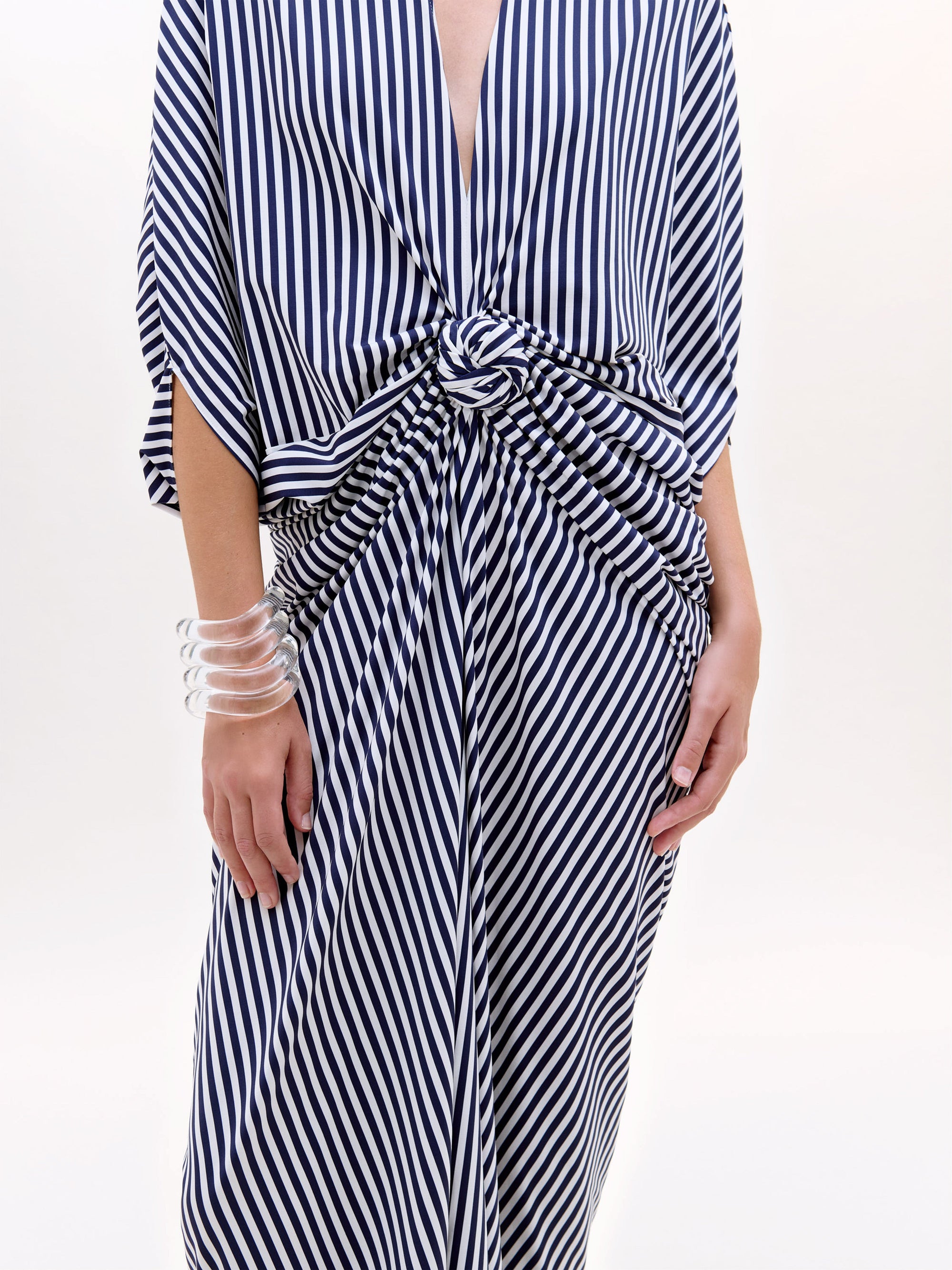 Black and white striped dress with a tie waist on a white background