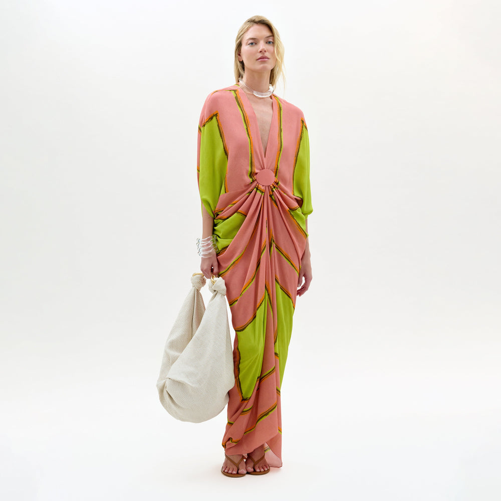Model wearing a colorful dress with a white background