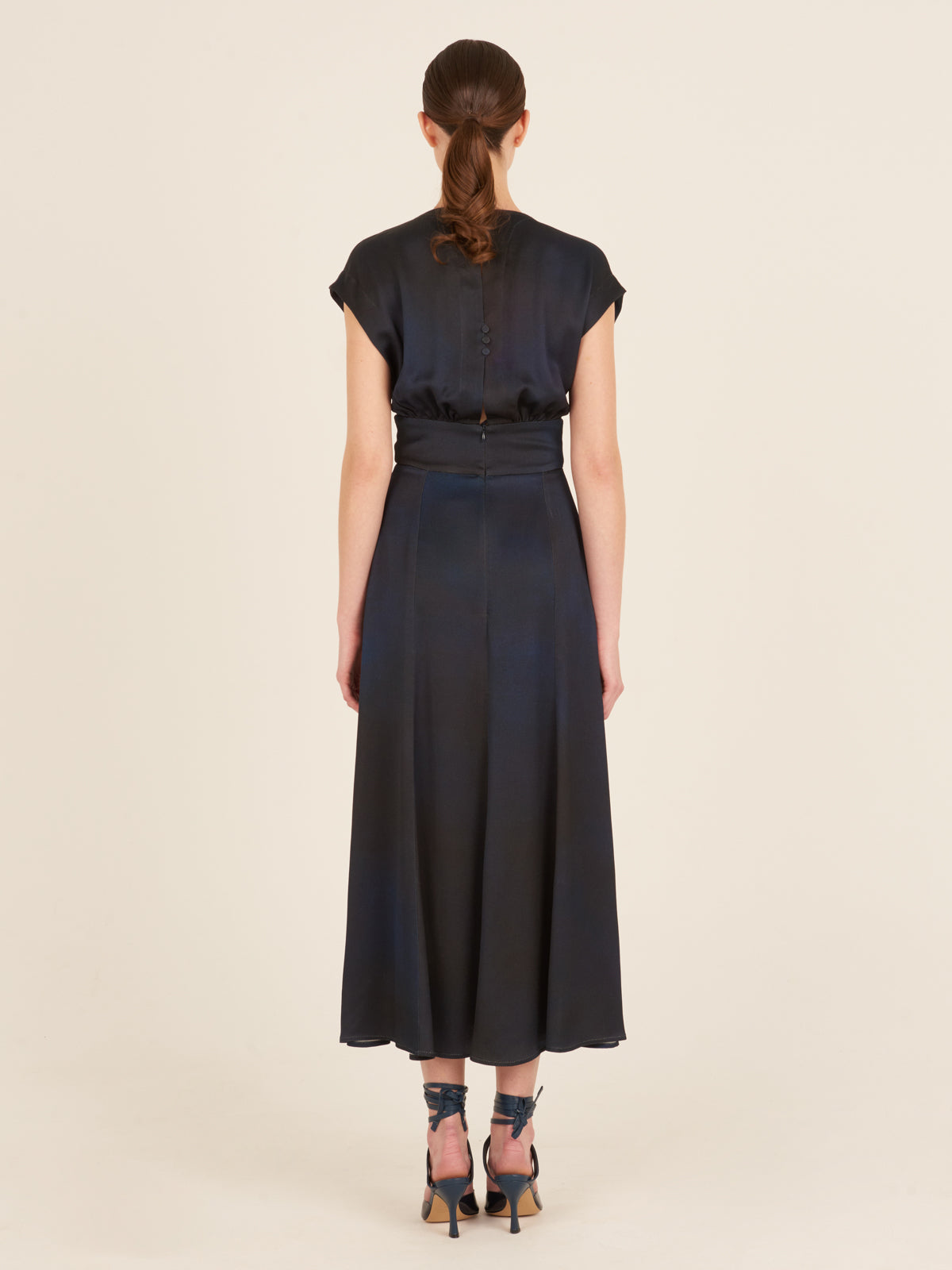 An elegant Emmeline Dress Navy with a buckle on the front.