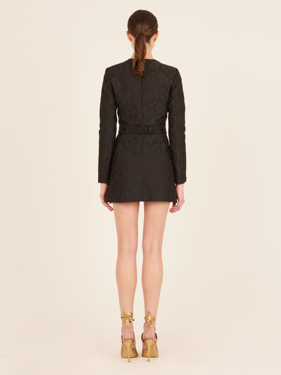 A Romana Dress Black with golden buckles.
