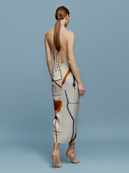 A model showcasing a Guadalupe Dress Cobalt Copper Abstract.