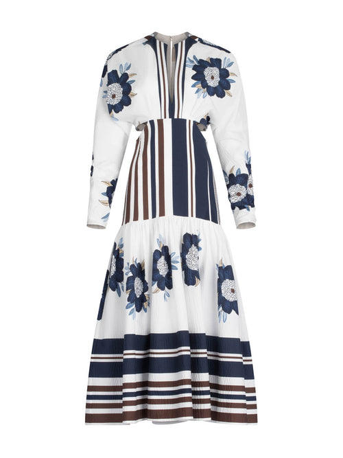 A long-sleeved Gabina Dress Multi Navy Brown Floral featuring a white base with blue floral patterns and horizontal navy stripes, designed with a flared skirt, isolated on a white background.