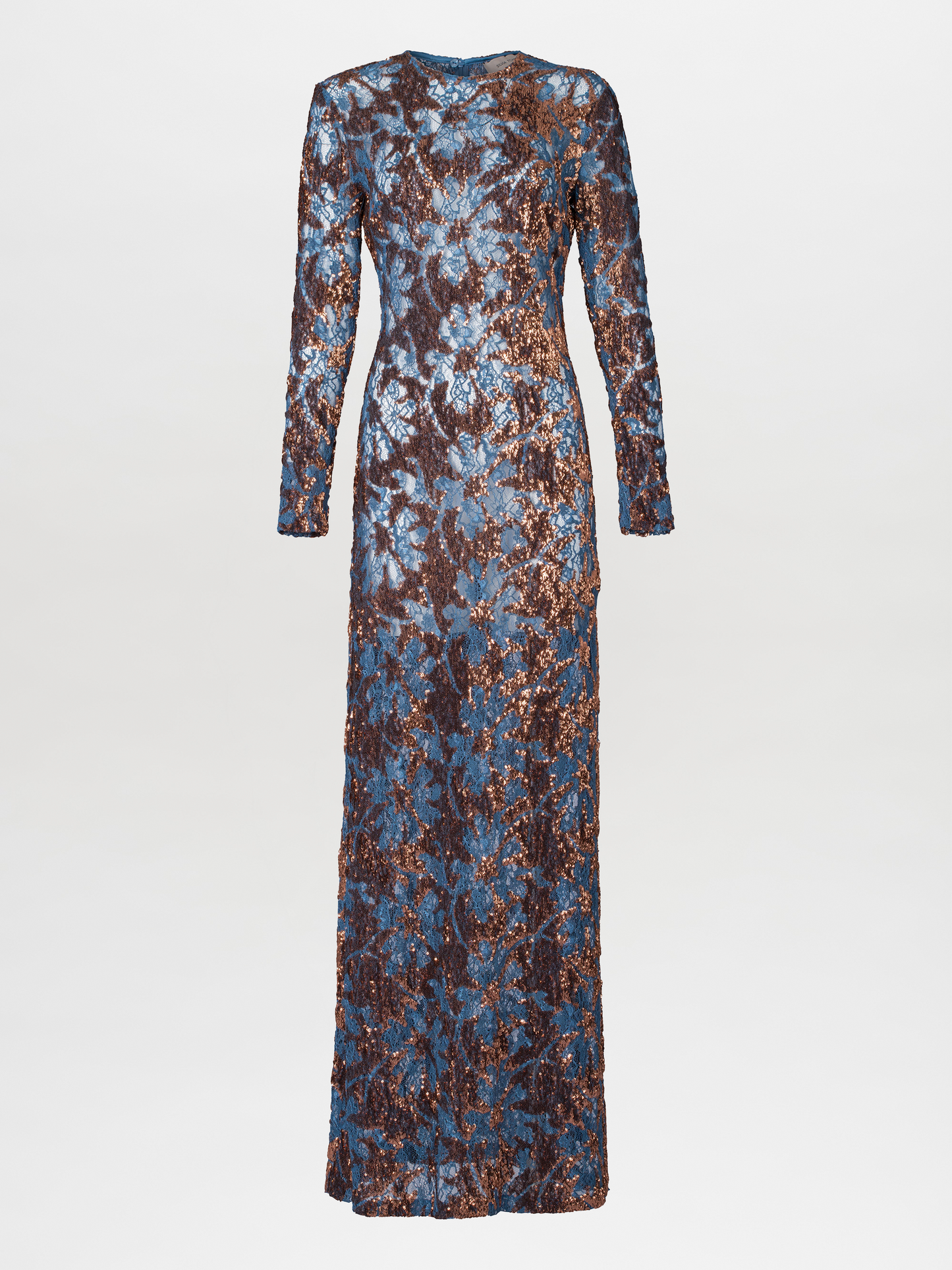 Person in the Ida Dress Navy Ochre Sequin, a long-sleeved, floor-length gown featuring an intricate blue and brown pattern, stands against a plain blue background, ready to dazzle at the gala on September 2nd.