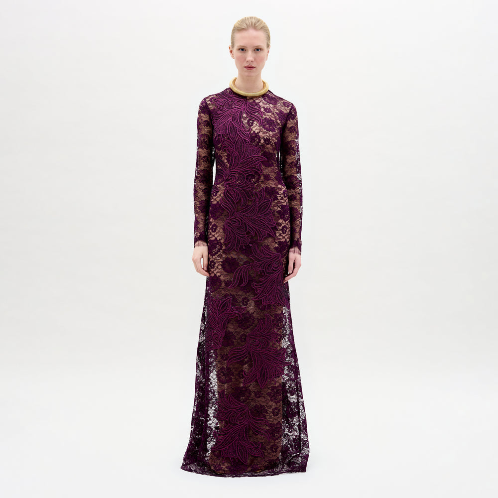 A woman wearing the Ida Dress in color Purple with a golden necklace on a white background.