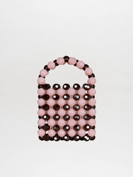 Introducing the Jasy Handbag Pink-Brown: a small, elegant beaded handbag with a handle, showcasing exquisite resin beading and alternating rows of pink and black beads, artfully crafted in Italy.