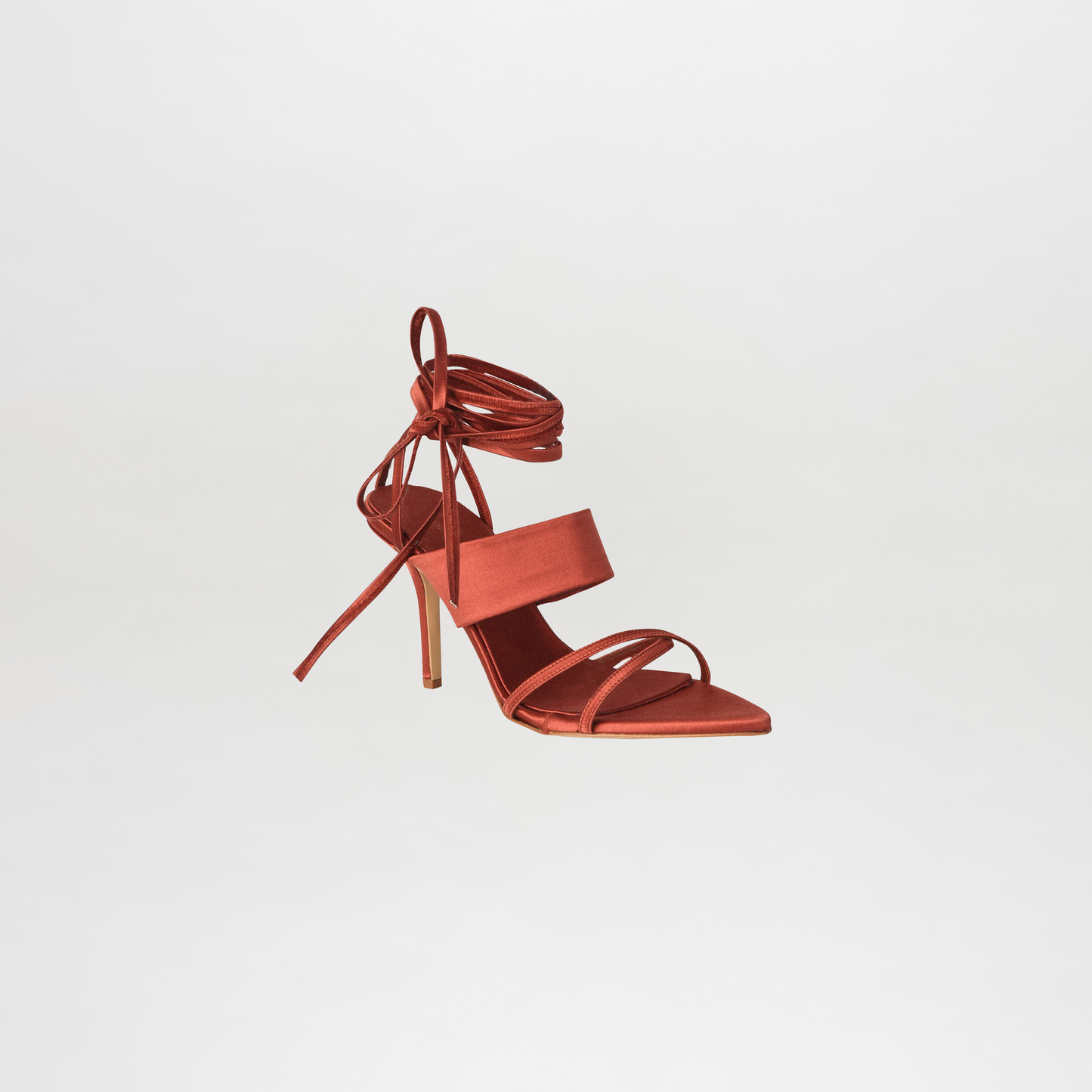 Red high-heeled sandal with strappy design on a light gray background