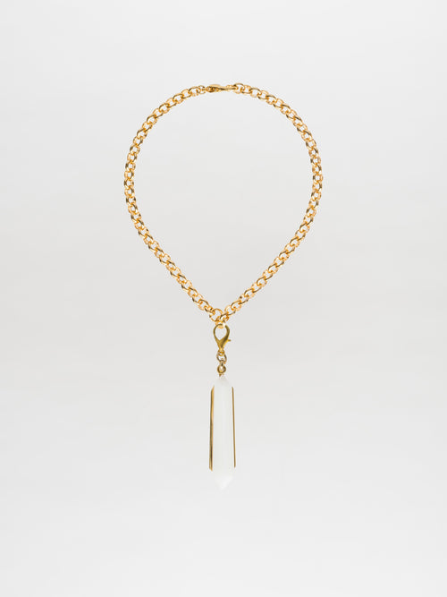 The Mariela Necklace Pearl is a gold-plated brass choker featuring a geometric crystal pendant, beautifully displayed against a white background.