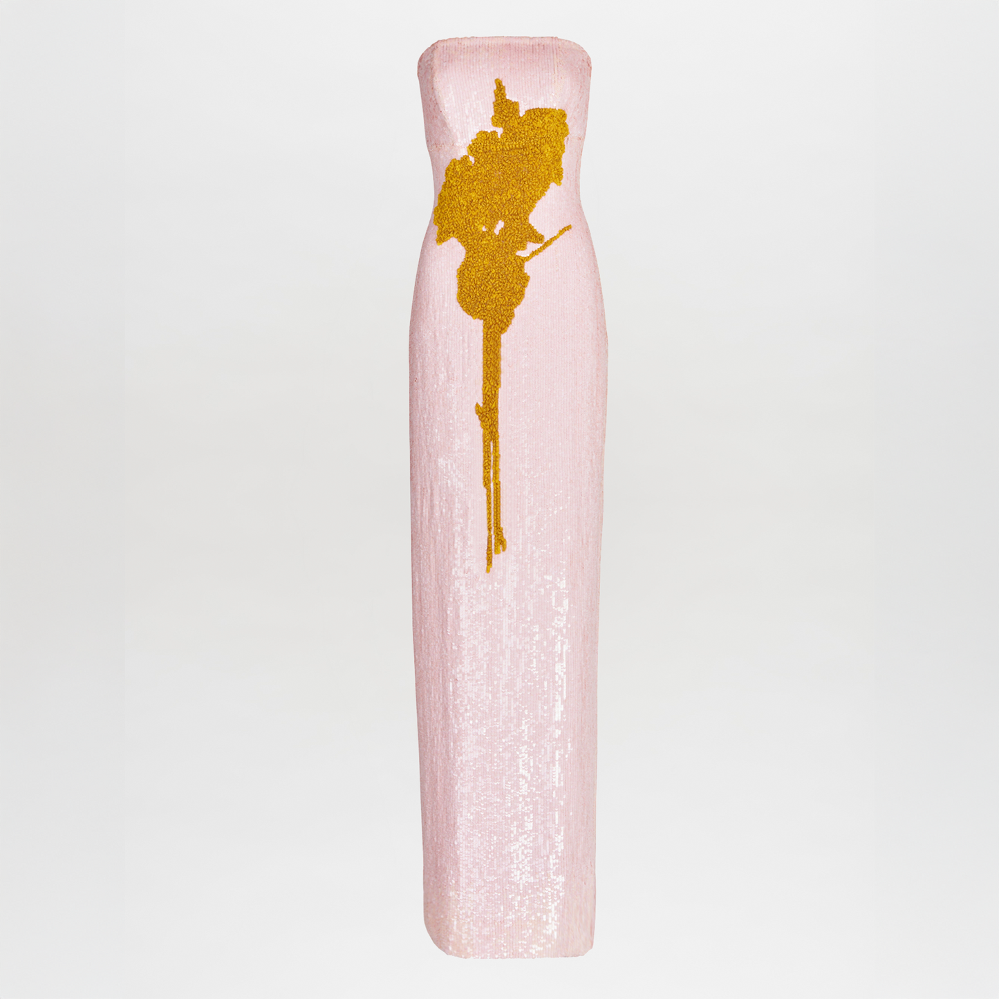 The Margaret Dress is a tall, slim blush evening gown featuring a strapless neckline and a vertical gold abstract design in shimmering sequin embroidery, standing out against a plain white background.