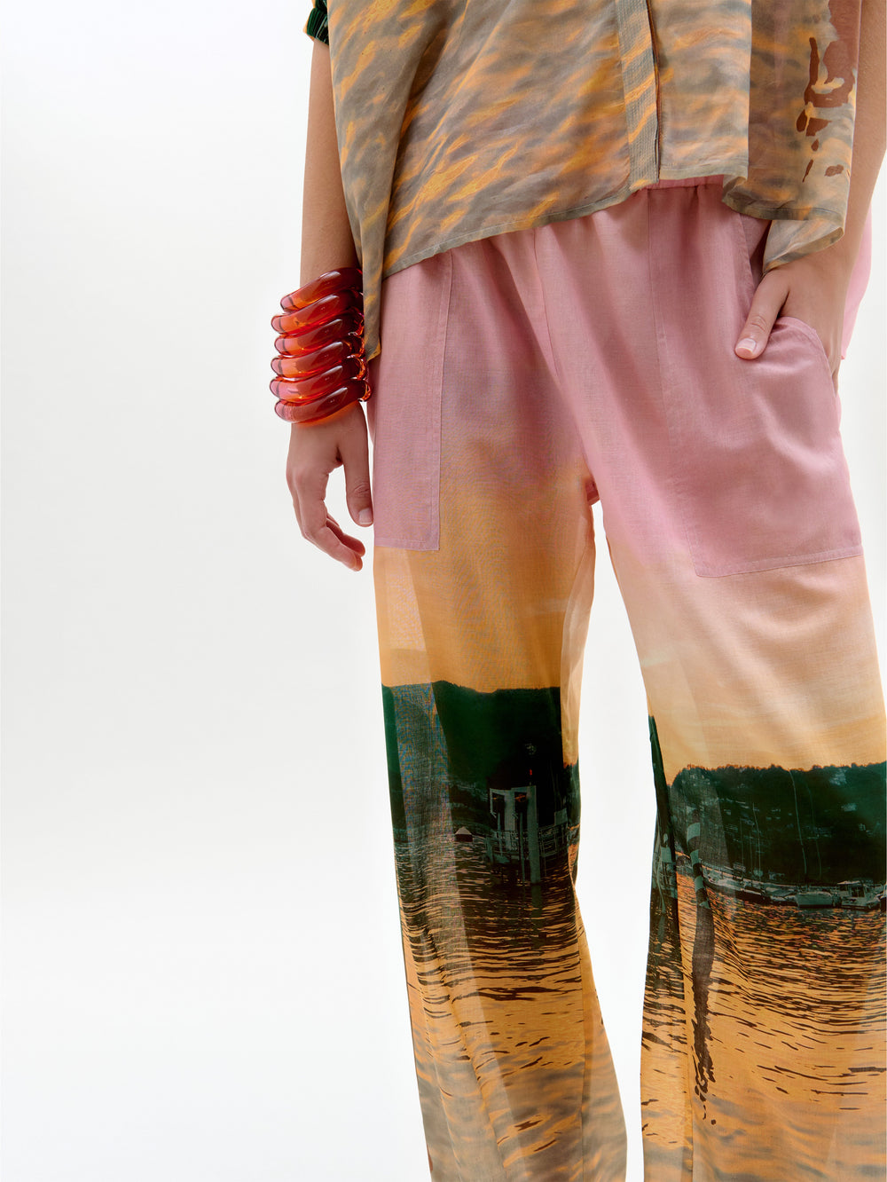 Colorful pants with abstract patterns worn by a person on a white background