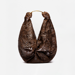 The Sofia Bag (Maxi) is a large brown bag with a crinkled texture, made from Italian fabric. It features a round gold-toned top handle and stands upright against a plain white background.