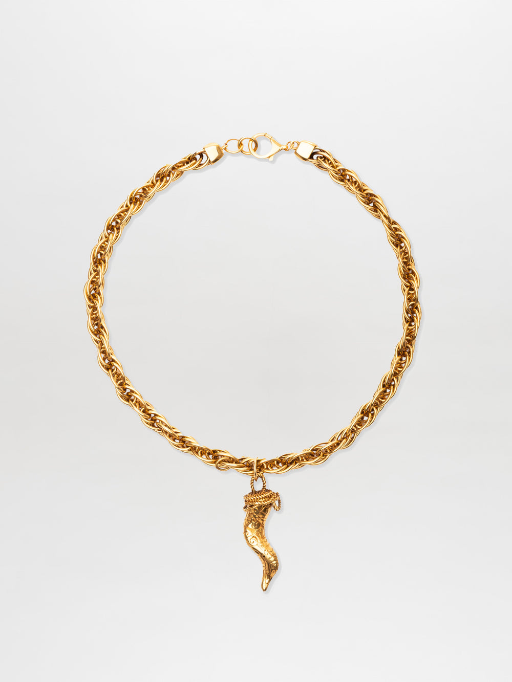 The Narumi Necklace features a gold rope chain with a lobster clasp and a single gold chili pepper-shaped pendant at the center.