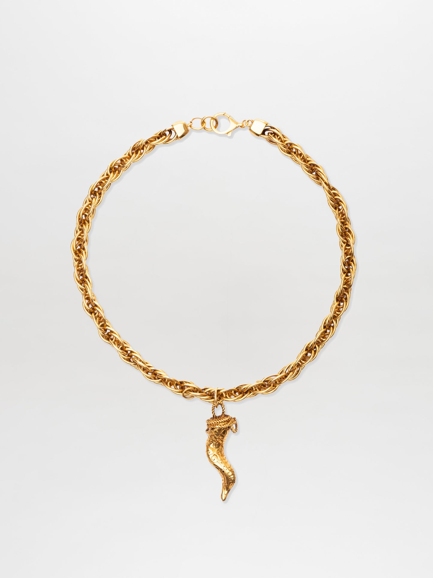 The Narumi Necklace features a gold rope chain with a lobster clasp and a single gold chili pepper-shaped pendant at the center.