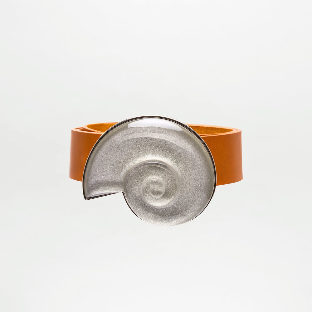Bracelet with orange band and silver spiral design on a white background