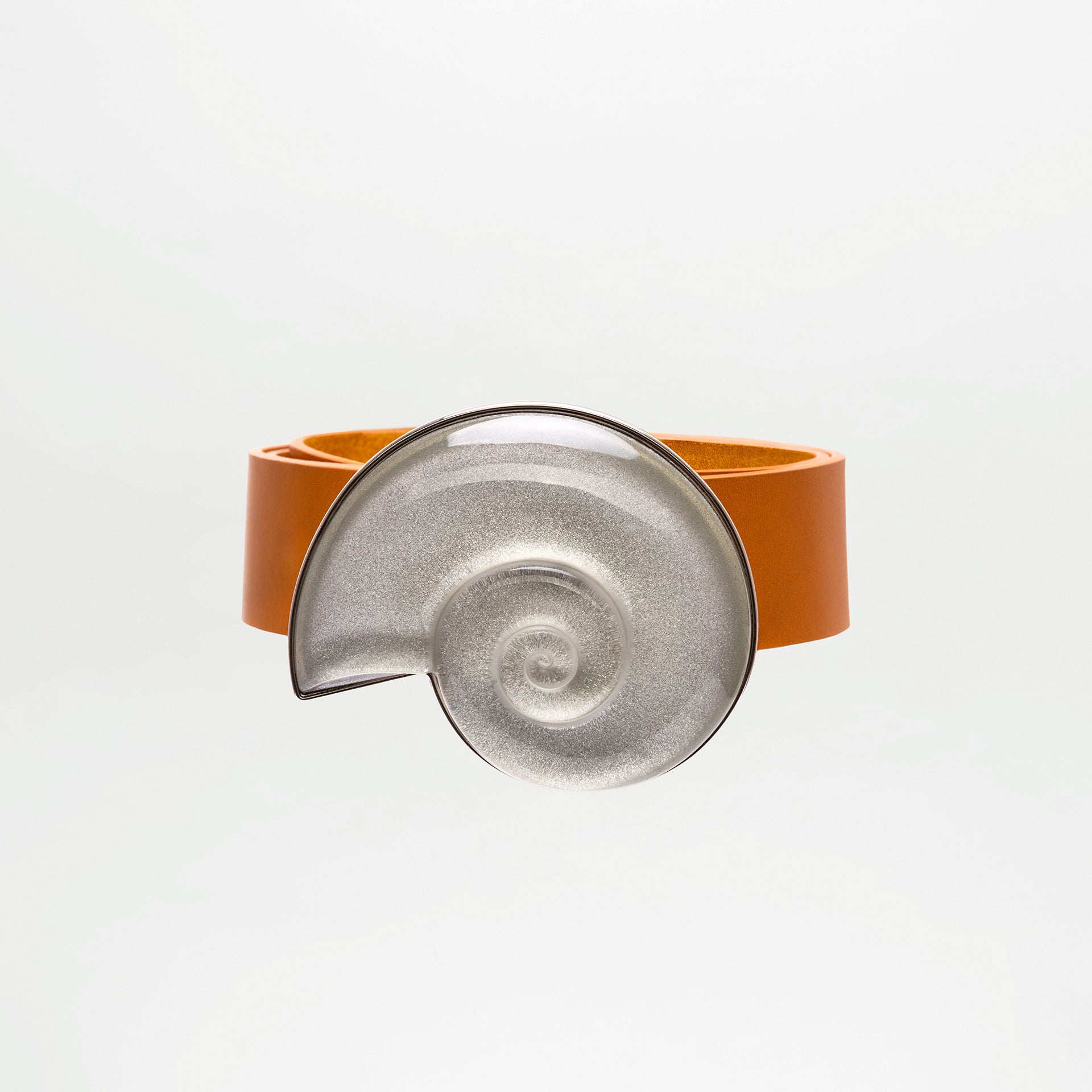 Bracelet with orange band and silver spiral design on a white background