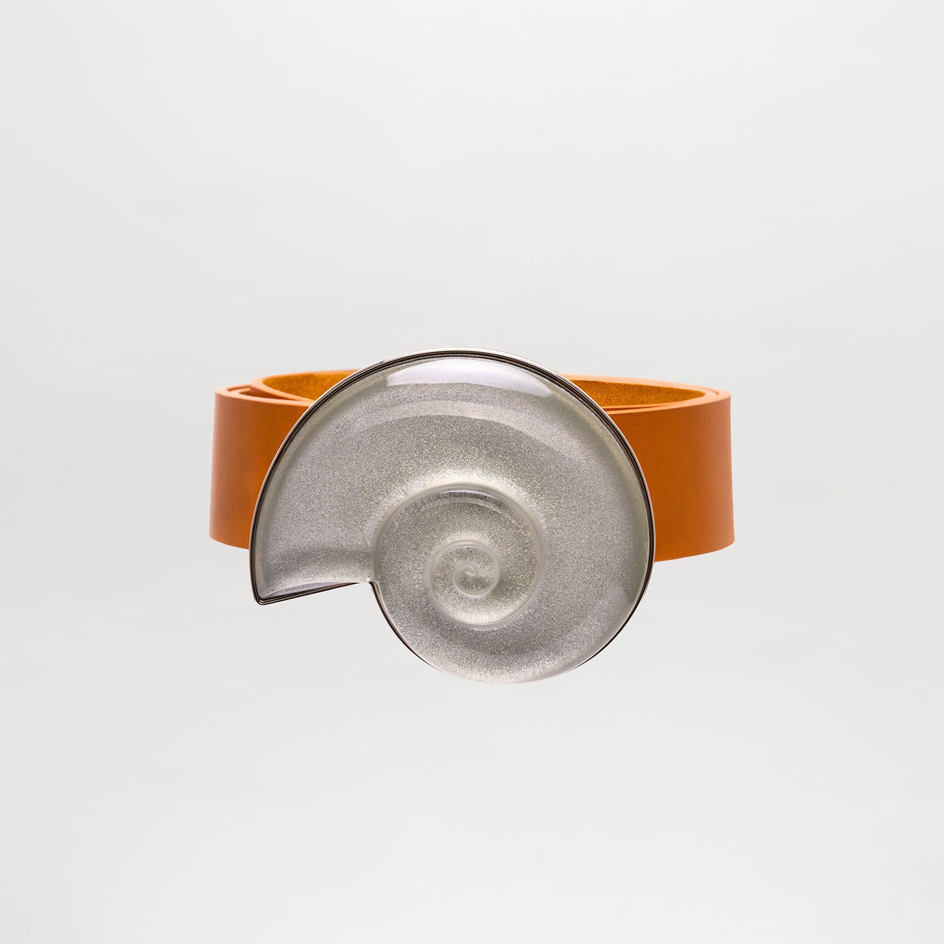 Ceramic bracelet with orange band on a light gray background
