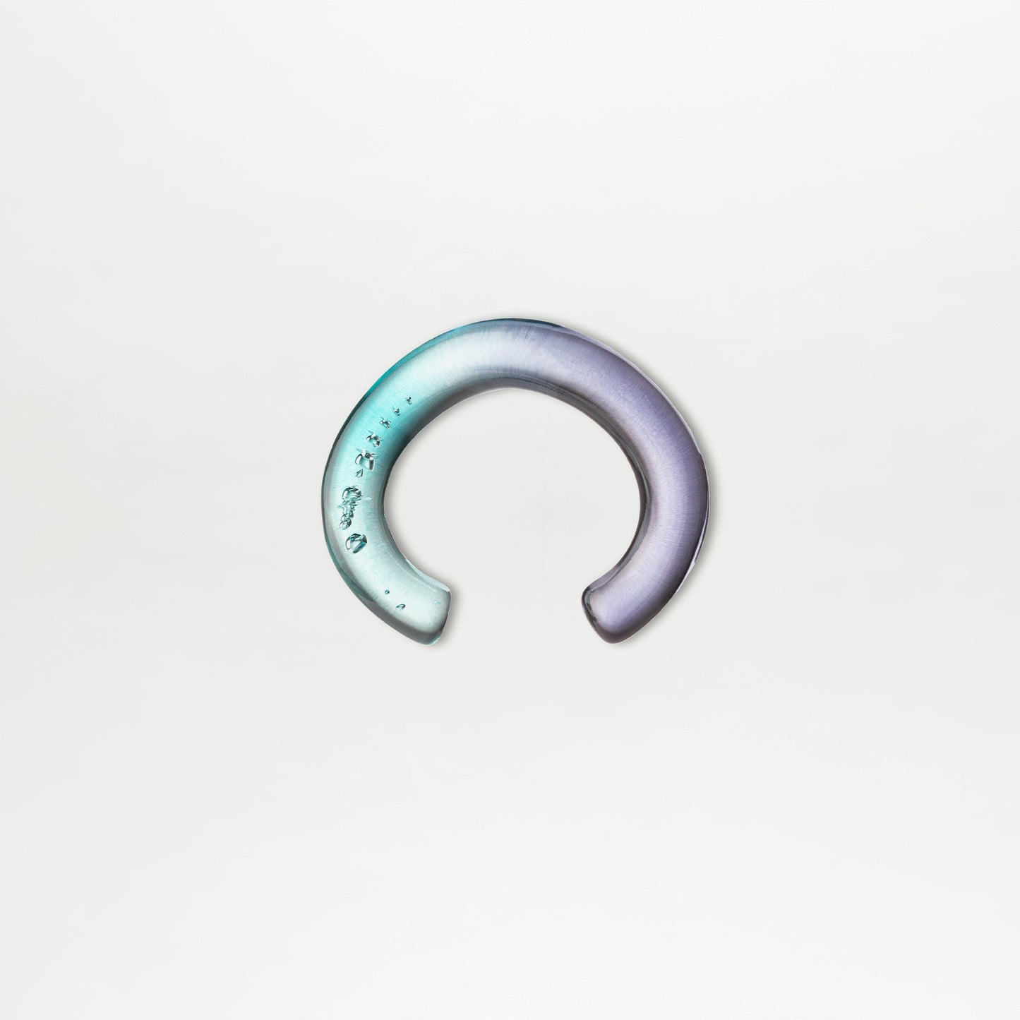 Gradient ear cuff on a light gray background