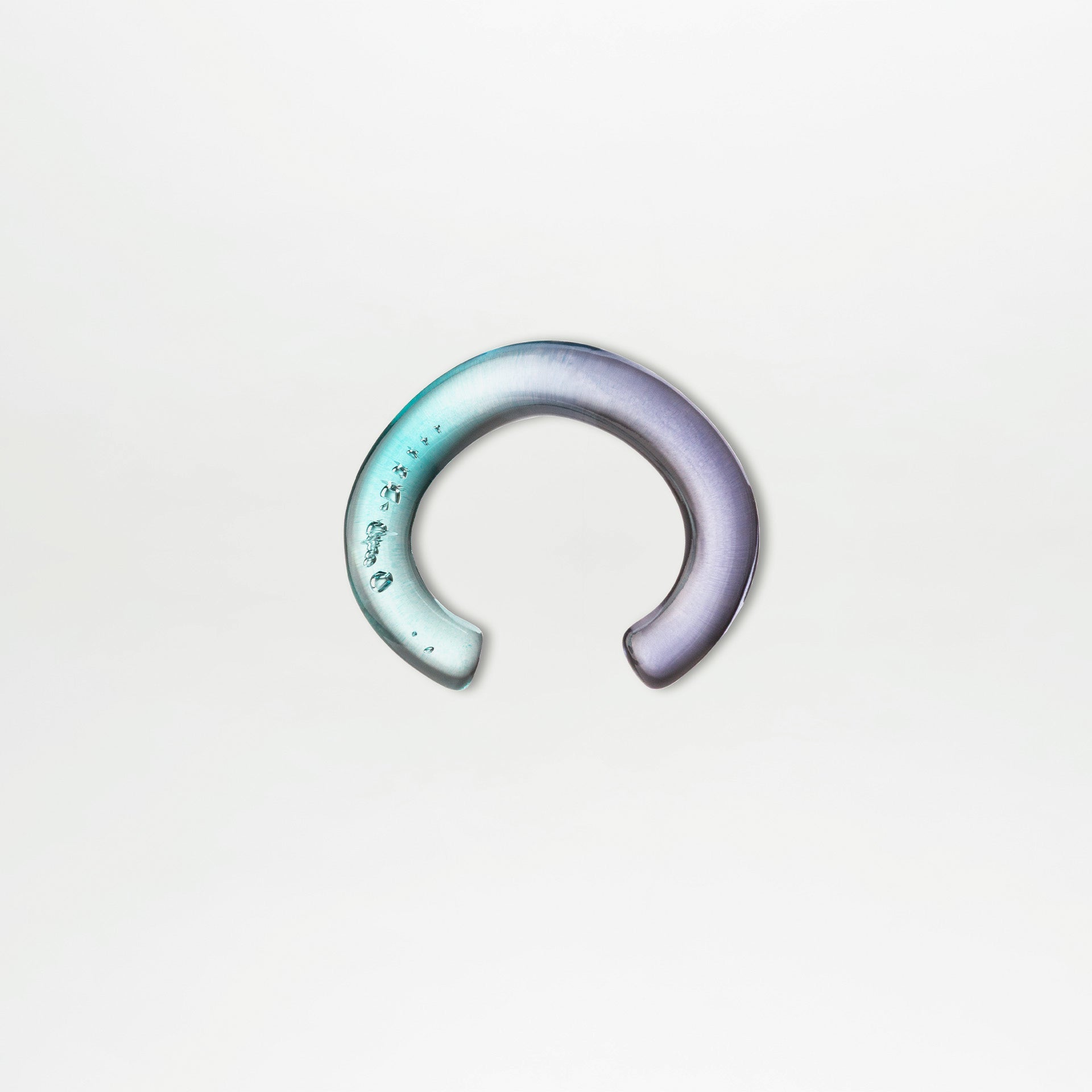 Gradient ear cuff on a light gray background