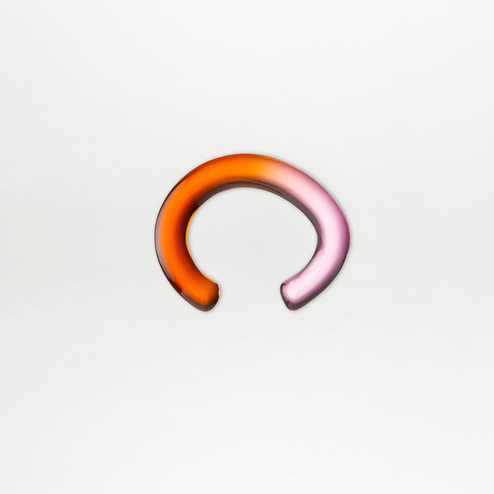 Multicolored ear cuff on a light gray background