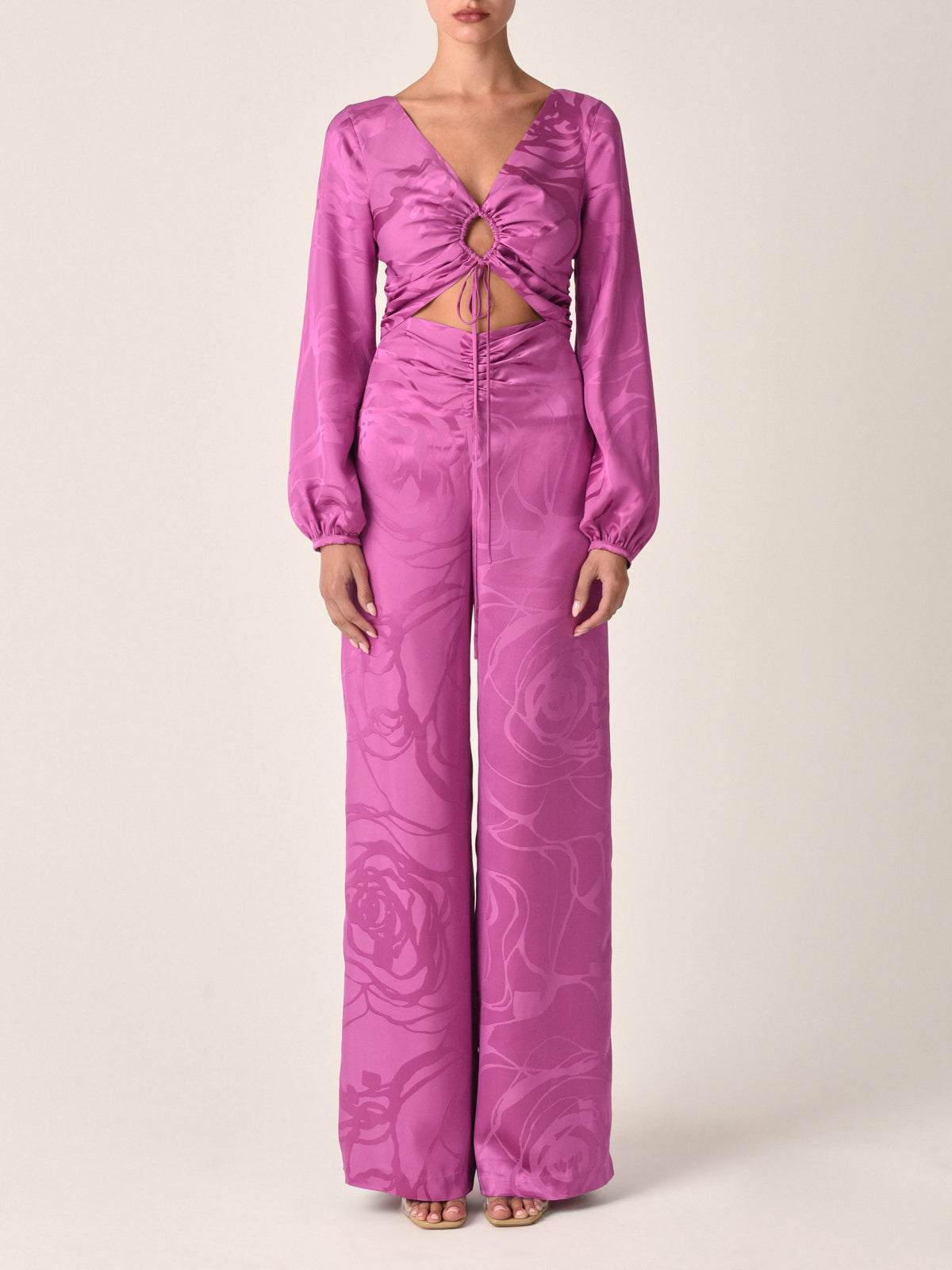 A magenta orchid jacquard, cropped, long-sleeved Odette blouse with a tie-front design and an abstract print, isolated on a white background.