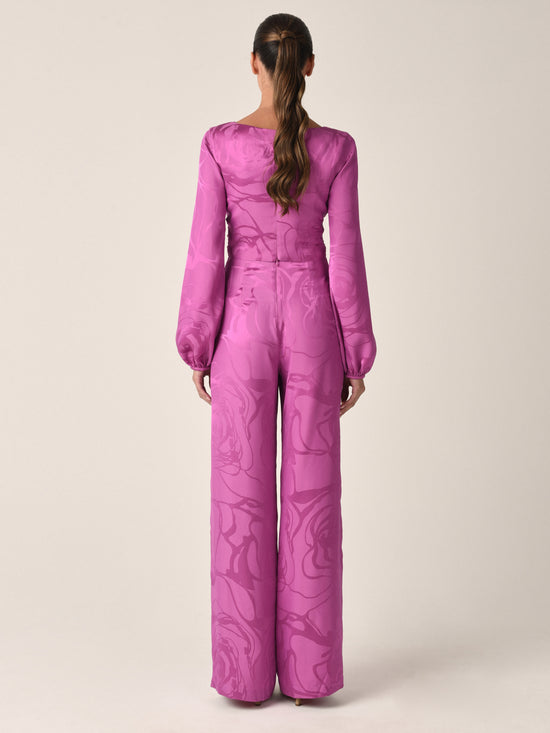 A magenta orchid jacquard, cropped, long-sleeved Odette blouse with a tie-front design and an abstract print, isolated on a white background.