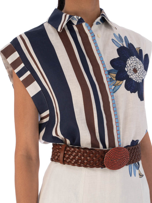 A sleeveless Rina Blouse Multi Navy Brown Floral with floral and striped patterns, featuring a pointed collar and a visible zipper on one side.