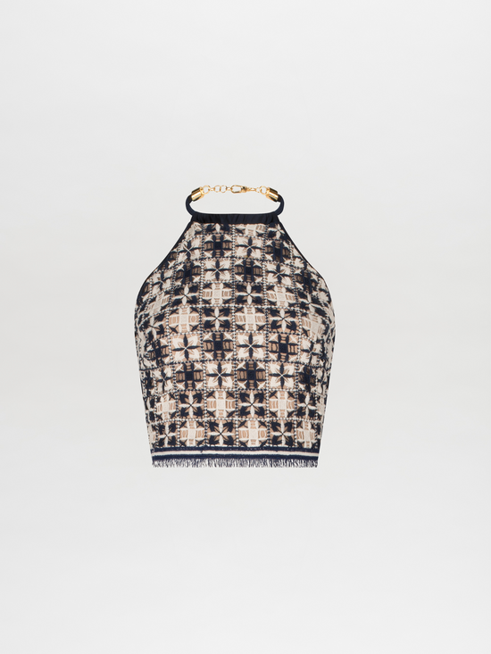 A Salma Top Navy White Crochet with a high neck and gold chain detail.