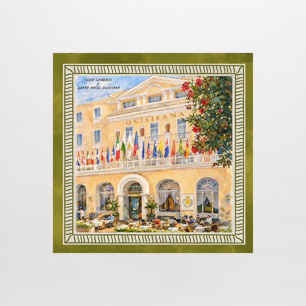 The Capri Scarf features a watercolor of the grand Quisisana hotel's exterior, with its name above the entrance, flags on the balcony, diners below, and a green-and-white decorative border.