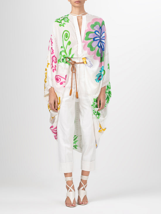 A white poncho with Adaya Tunic Multicolor Floral Print designs.