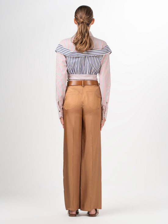 Elevate your style effortlessly with our Emine Pant Khaki, featuring a wide-leg silhouette and high-waisted design. Crafted from 100% viscose, these pants provide both comfort and elegance with their front button and zipper closure.