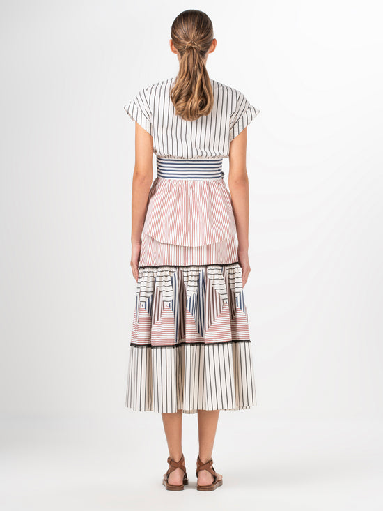 A white and blue striped Elia blouse with a bow, made of cotton fabric.