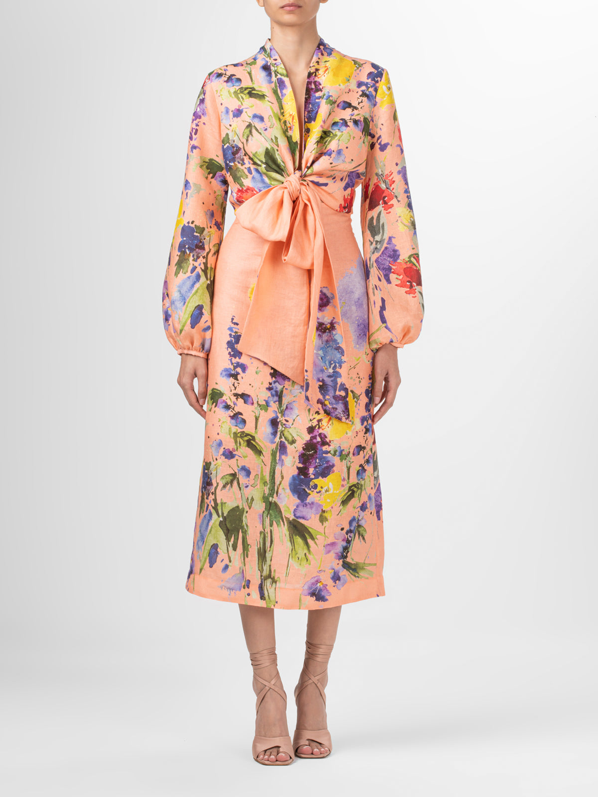 A high-waisted midi Atira Skirt Apricot Spring Garden with a multicolor floral print.