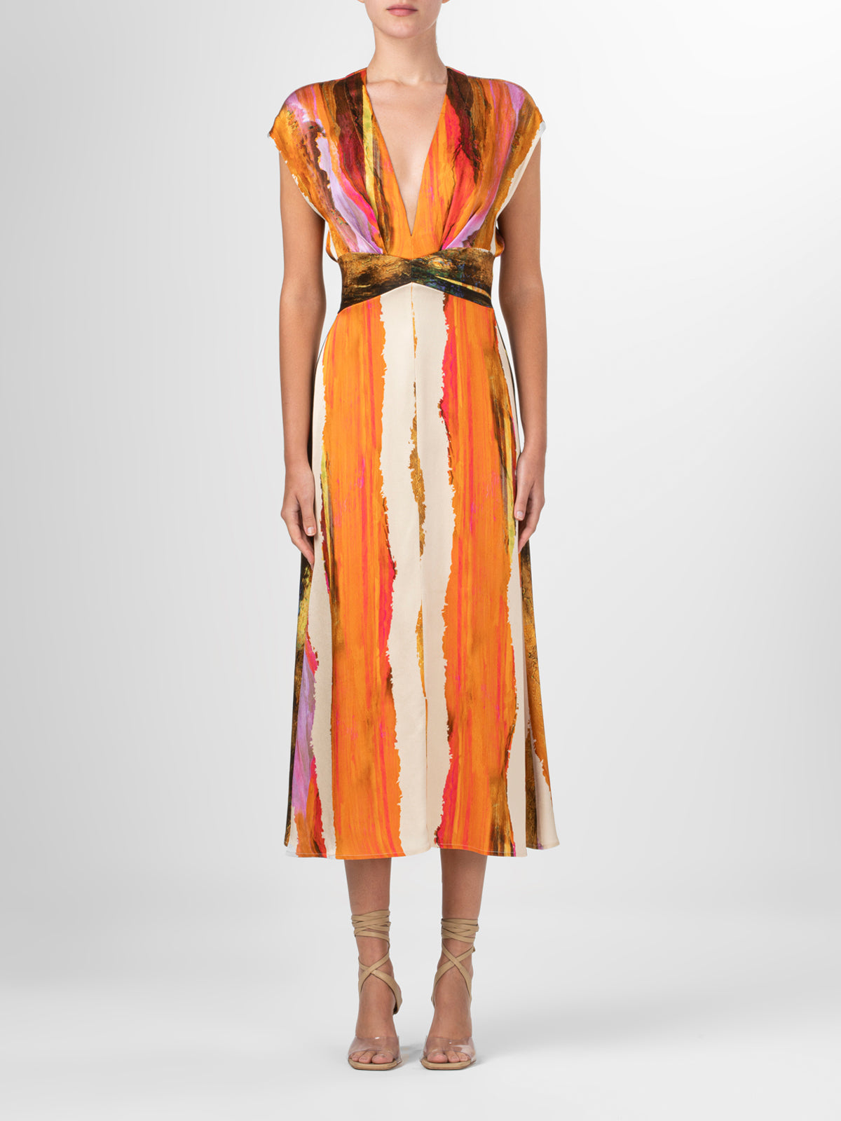 A Ivanova Dress Orange Orchid Abstract Stripes displayed on a mannequin with a V neckline.