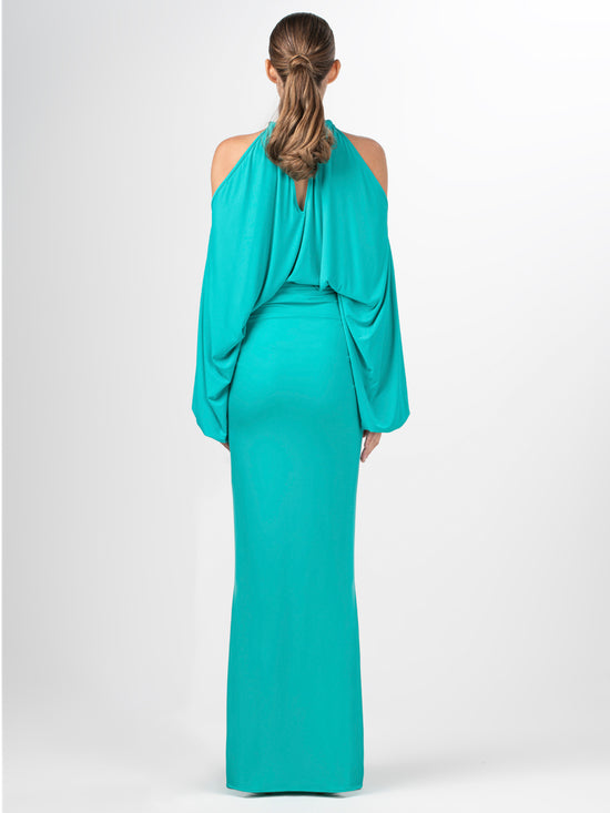 A Janina Blouse Aqua with a metallic jewelry detail around the neck.