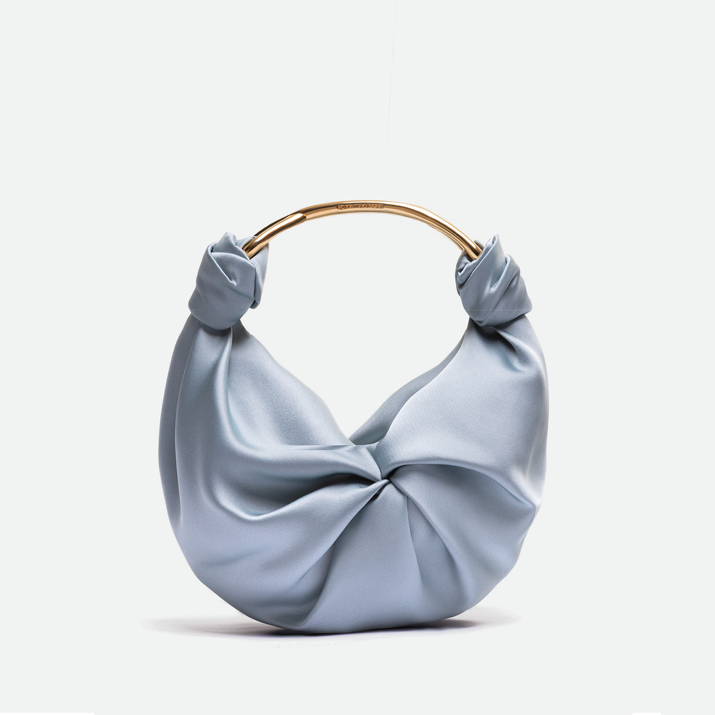 Light blue handbag with a gold handle on a white background