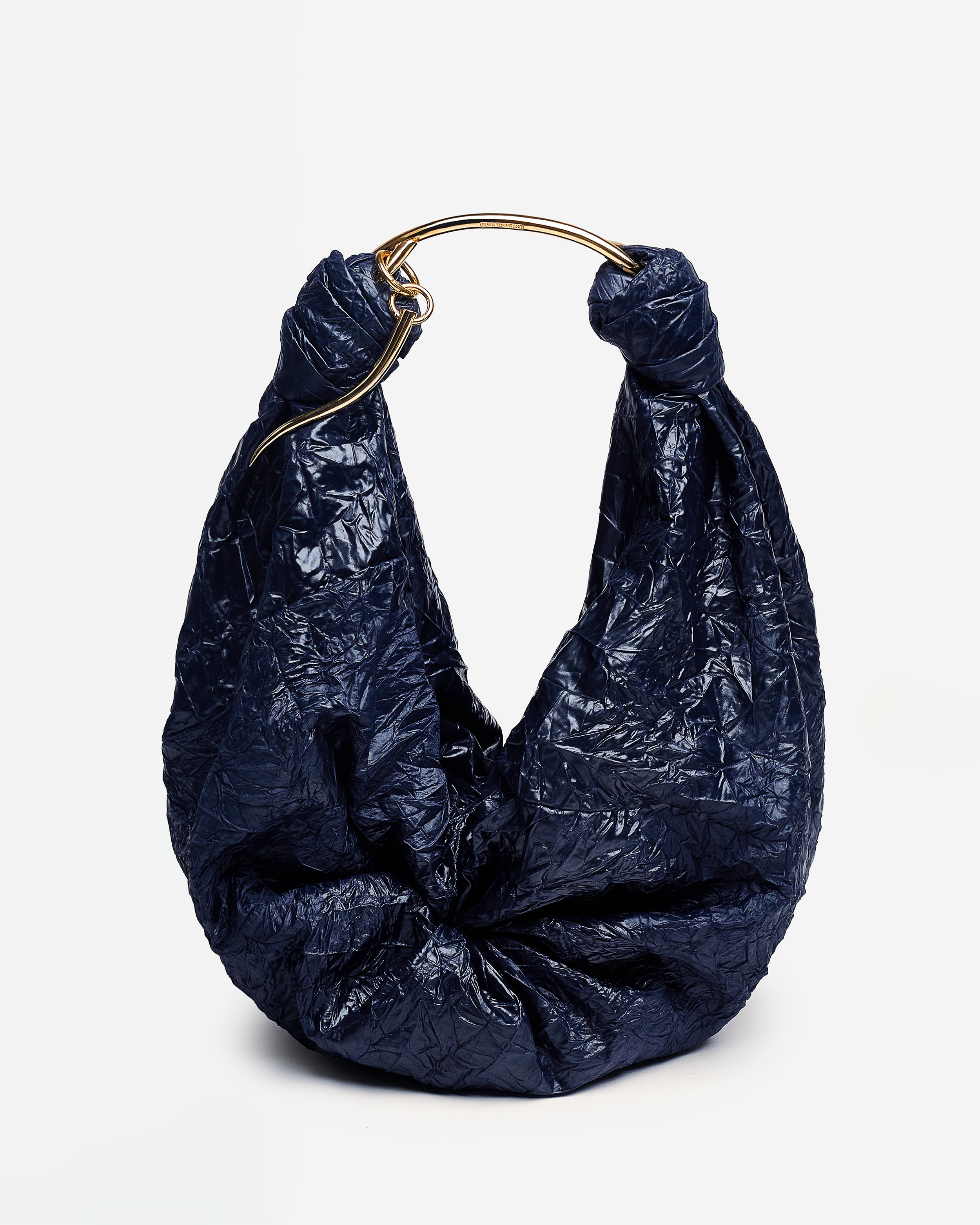 Navy blue Sofia Bag with a gold handle on a light gray background