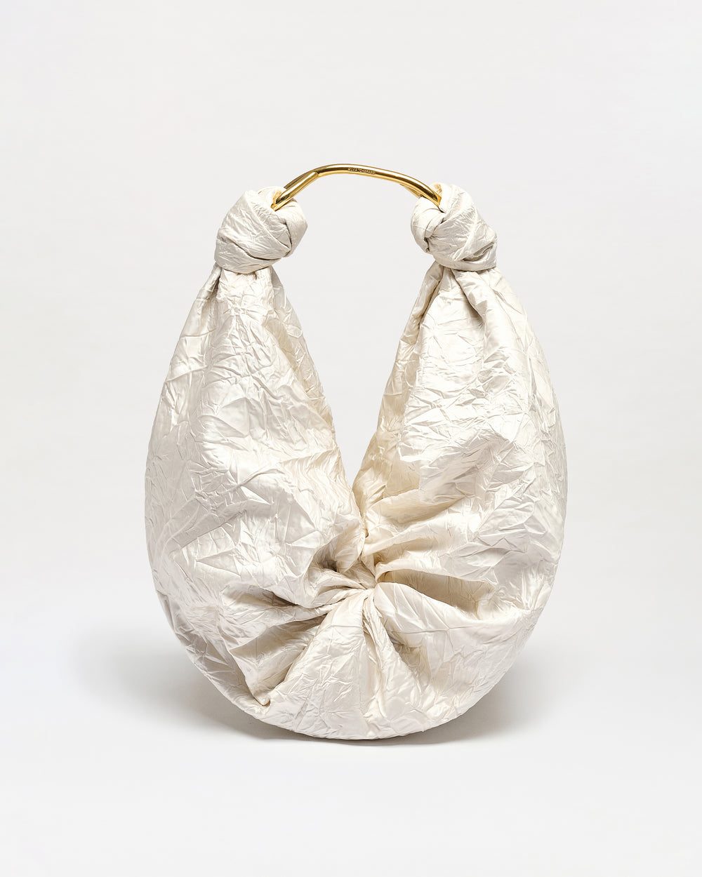 Off white textured Sofia Bag with gold handle on a light gray background