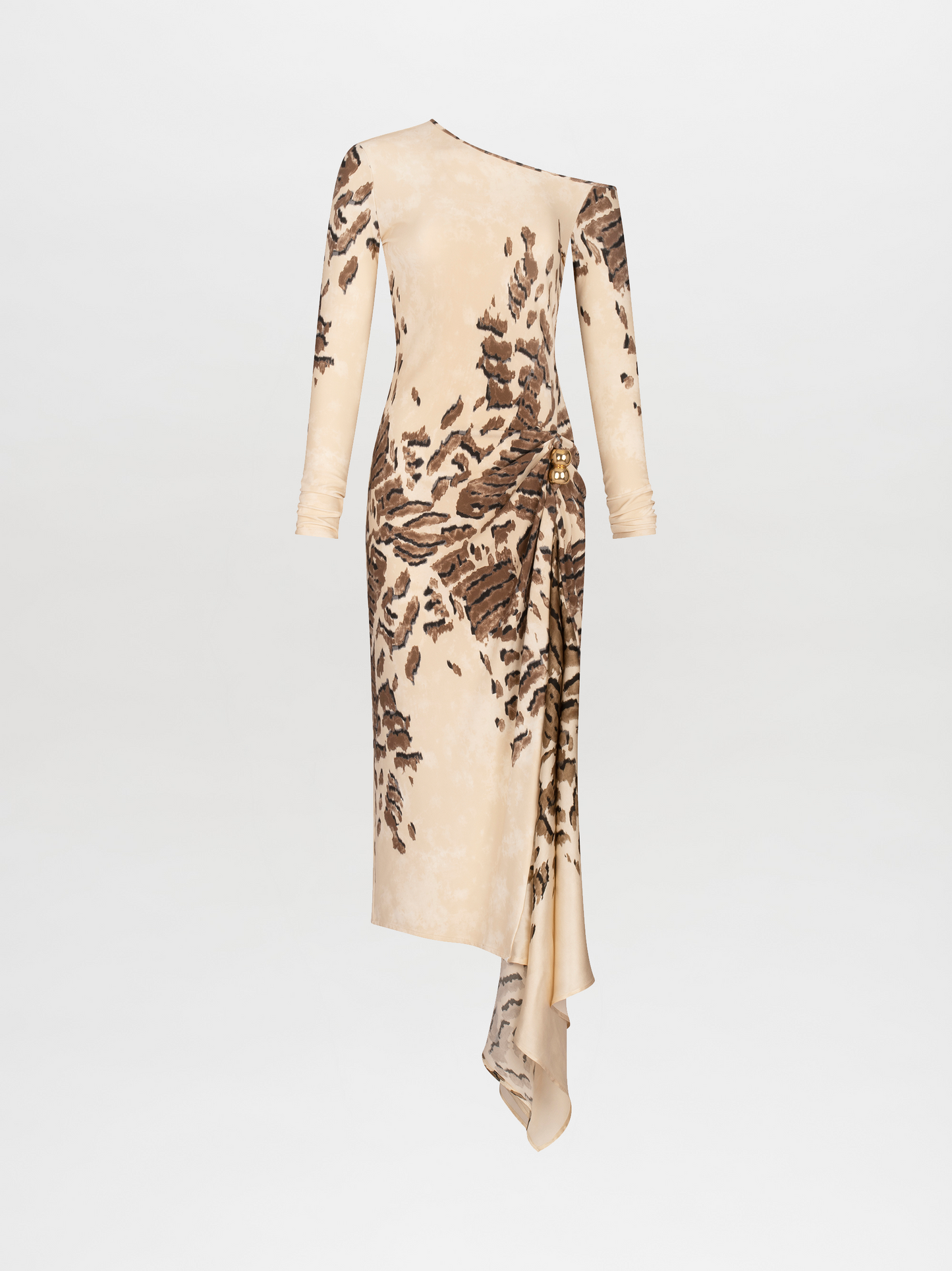 A woman in an off-shoulder, floor-length Tahia Dress Beige Abstract Animal Print stands against a plain background, holding a large beige bag in one hand. She is wearing gold sandals and a gold choker. Mark your calendars for November 15th—this stunning look is available for pre-order ahead of its 2024 launch.