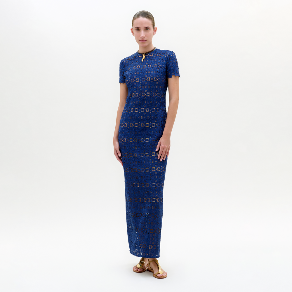 Woman wearing a blue patterned dress on a white background
