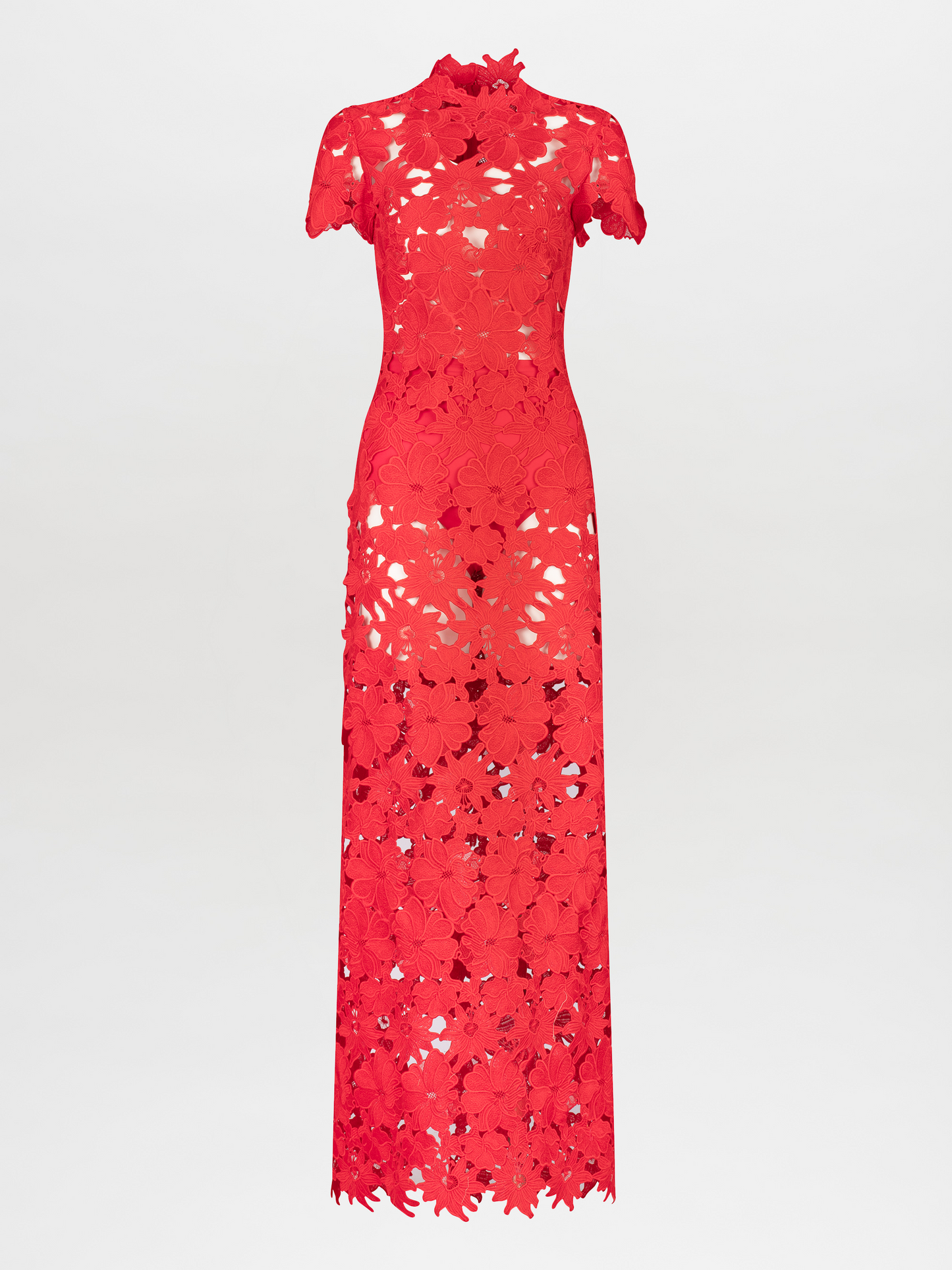 Person wearing a floor-length, red lace Taiana Dress Rouge with a high neckline and short sleeves, standing against a plain white background. Pre-order now to ensure delivery by the November 15th, 2024 ship-by date.