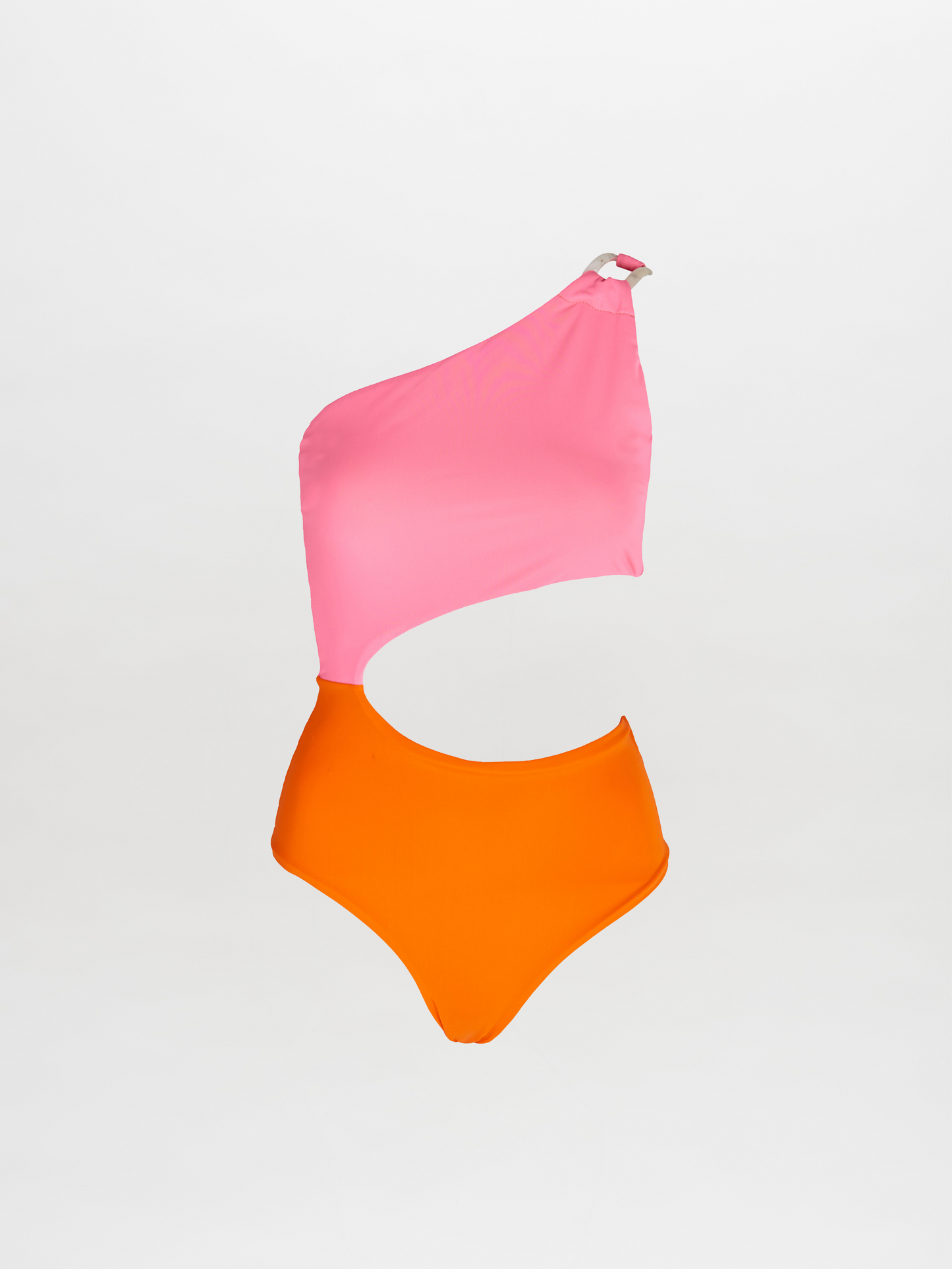 The Tropea One Piece is a color-blocked one shoulder swimsuit with a pink top, orange bottom, and an asymmetrical waist cutout, shown on a plain white background.