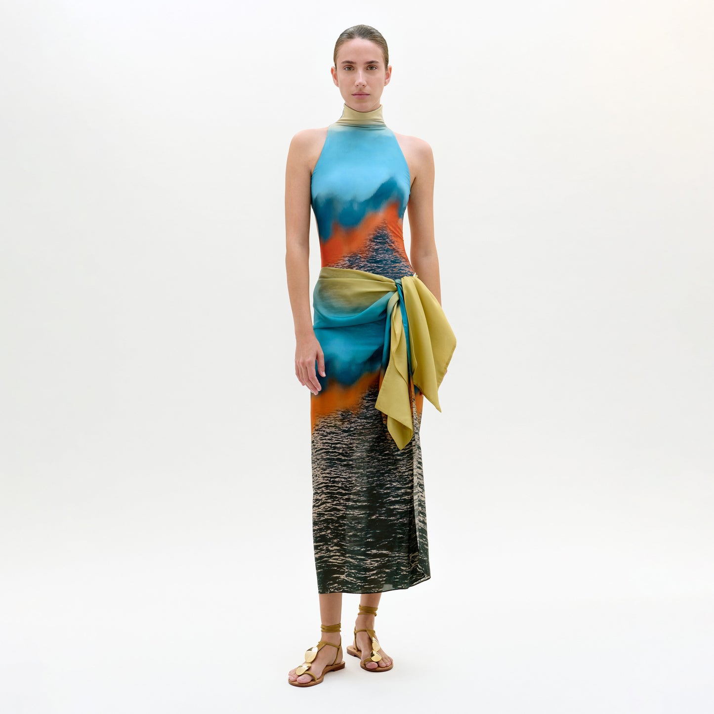 Model wearing a colorful dress with a gradient effect on a white background