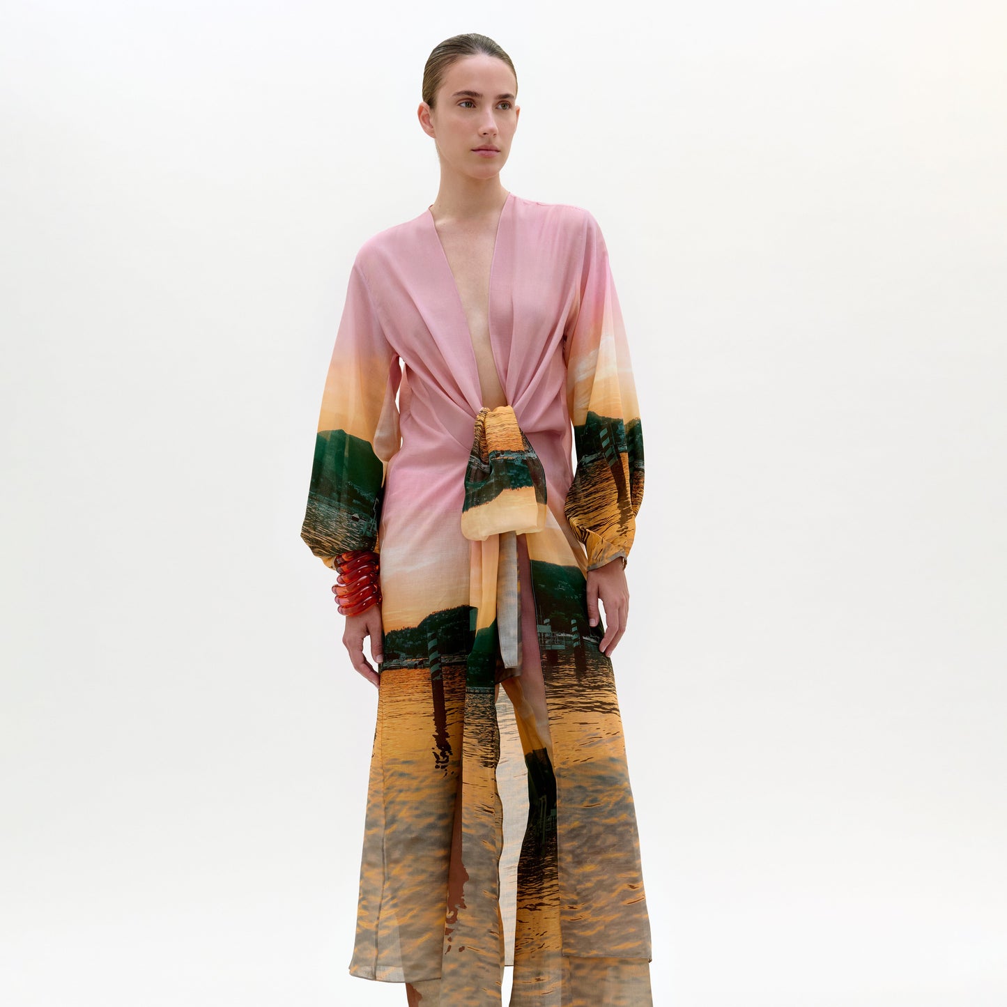 Woman wearing a colorful kimono-style outfit on a white background