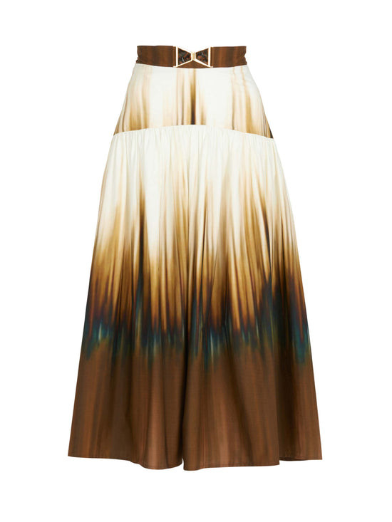 A lightweight cotton ombre Damla skirt with a belt in a Tuscan Sunset print.