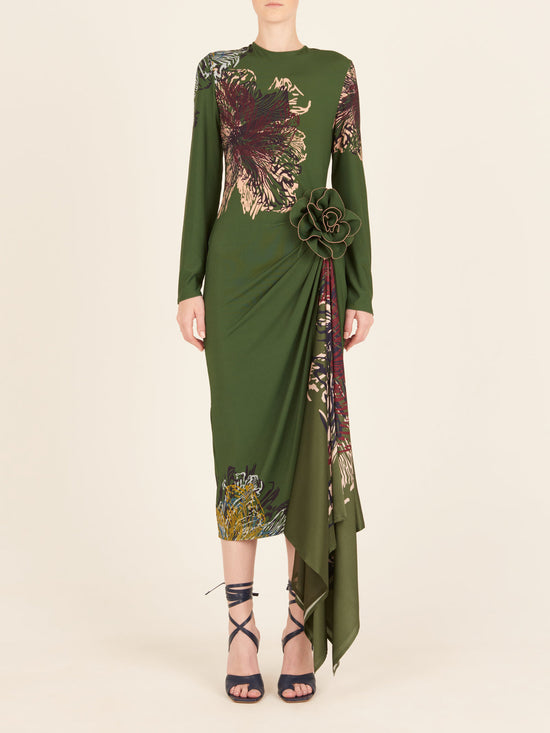 Ananya Dress Green Floral long-sleeve dress with an asymmetric hem, featuring a fabric flower embellishment on the side.