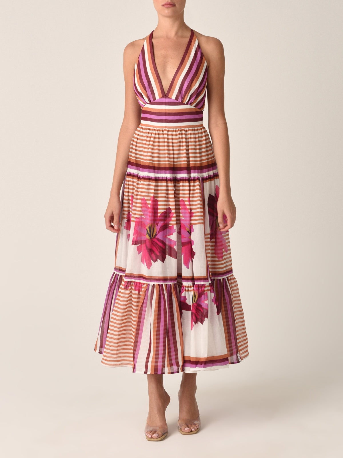A Valerie Dress Magenta Floral Brushstroke Stripes with pink, peach, and white stripes and transparent sections with magenta floral brushstroke designs, isolated on a white background.