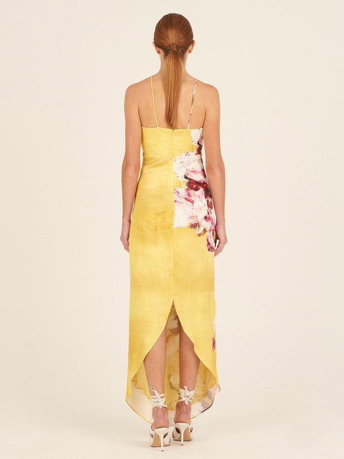 A yellow sleeveless Aisha Dress Canary Pink Flowers, with thin shoulder straps, isolated on a white background.