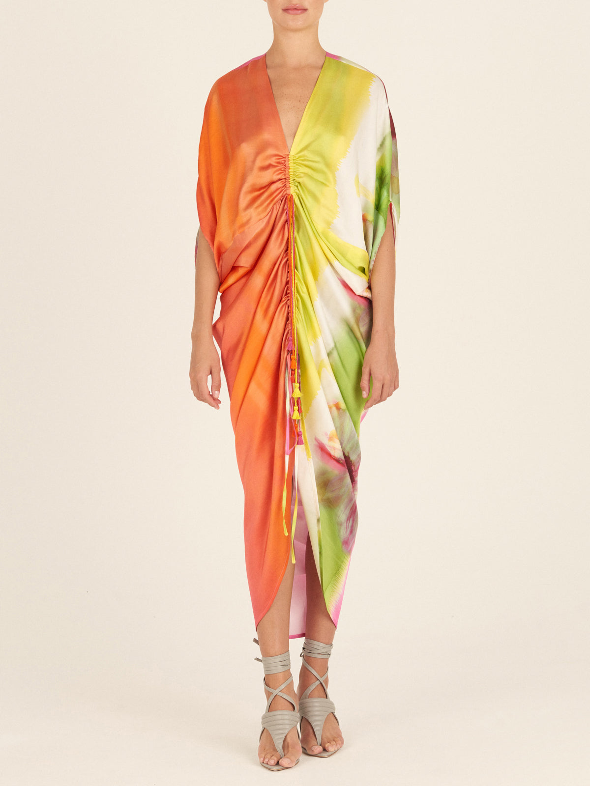 A versatile, colorful silk scarf with a Cloister Dress Floral Gradient Rainbow print on a mannequin.